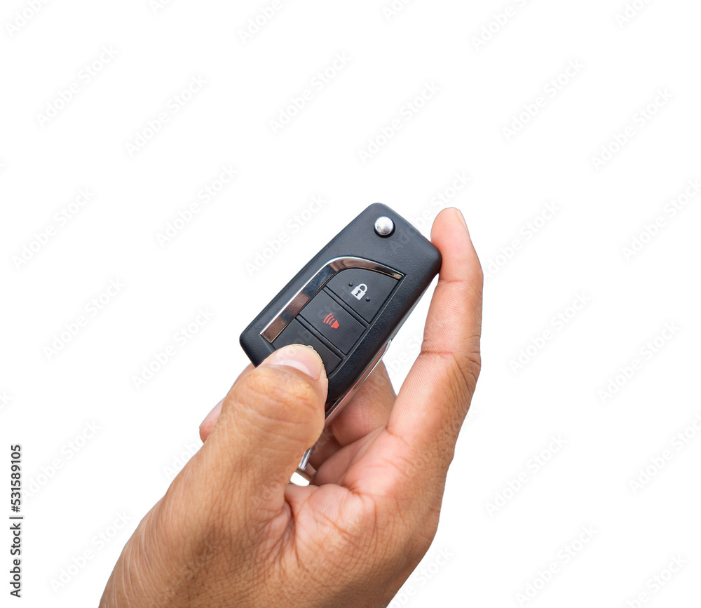Fototapeta premium Hand pressing the button on the remote to lock or unlock the car with the remote control.