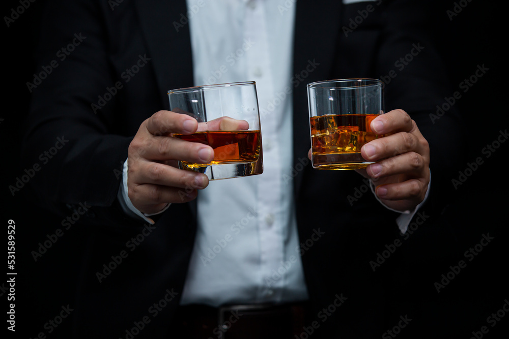 Closeup businessmen holding a glass of whiskey Closeup businessmen holding a glass of whiskey