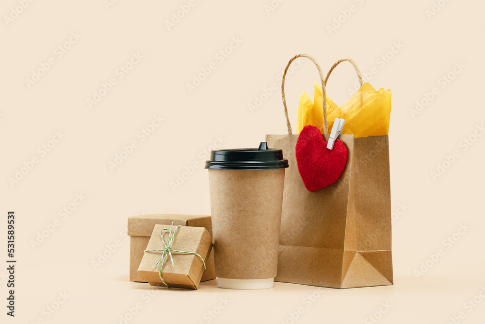 Takeaway paper coffee cup with lunch bag with red felt heart and gift ...