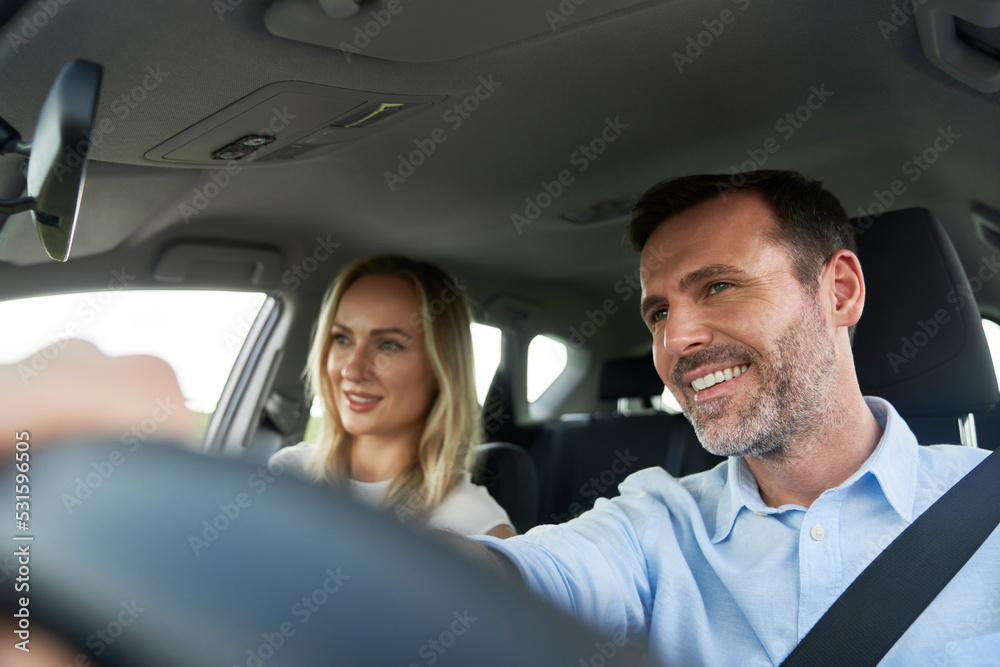 Cheerful caucasian of middle age couple during a car trip Cheerful caucasian of middle age couple during a car trip