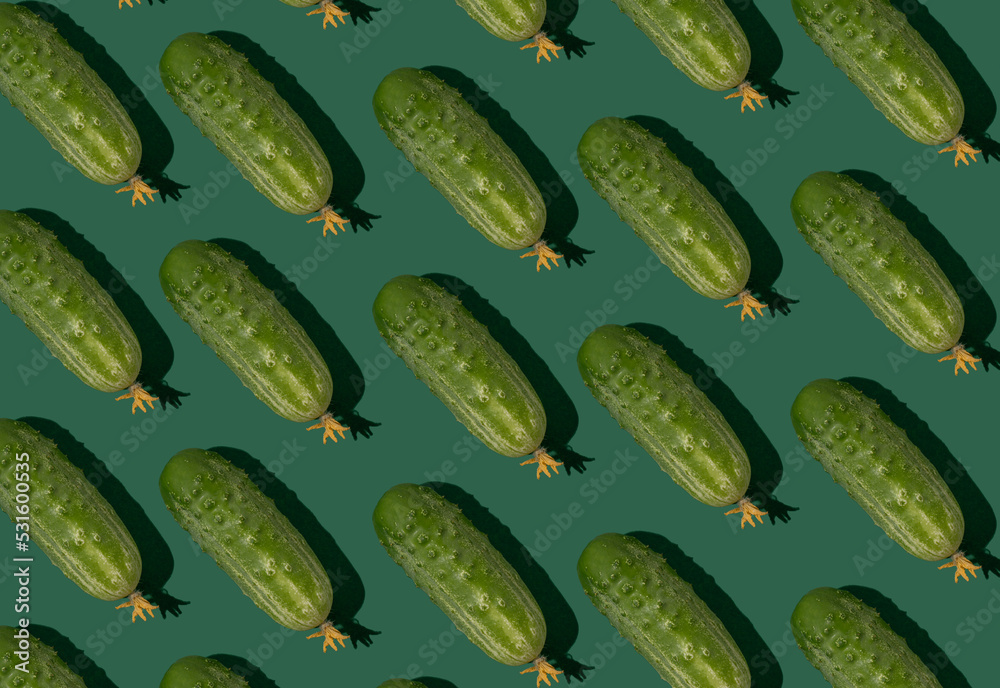 Cucumber pattern. Cucumbers on a green background. Vegetables food Cucumber pattern. Cucumbers on a green background. Vegetables food