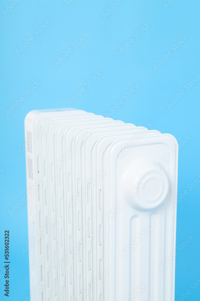 Modern white electric heater on blue background Modern white electric heater on blue background