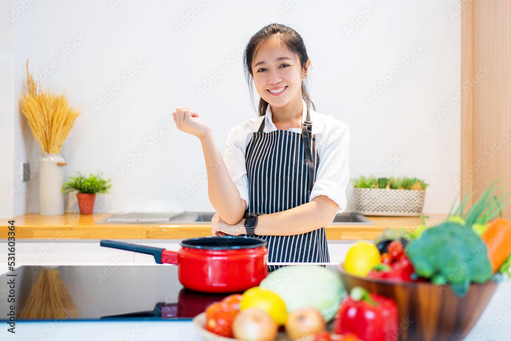 Young asian woman cooking in the kitchen Young asian woman cooking in the kitchen