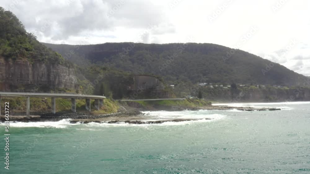 Drone shot flying parallel to the Sea Cliff Bridge in New South Wales, Australia Drone shot flying parallel to the Sea Cliff Bridge in New South Wales, Australia