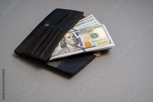 American dollar banknotes stack, pack of money in black wallet, rich, luxury, currency, spending money in crisis, benchmark currency, most used in transactions across the world  photo