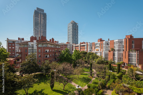 Sunny day in green european courtyard. Modern residential complex in Barcelona, Spain