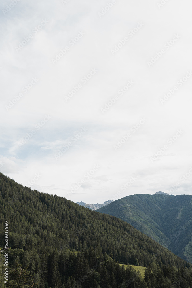 Scenic view of mountains, valley, forest, sky with clouds. Landscape
