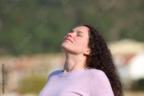 Woman with curly hair breathing fresh air