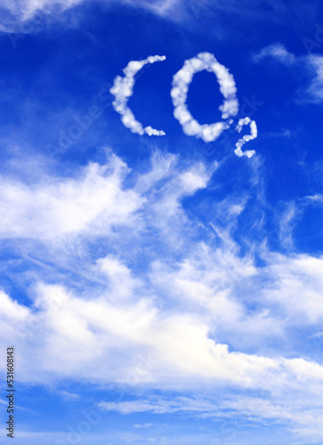 Symbol CO2 from clouds on blue sky. Pollution, global warming and climate change concept