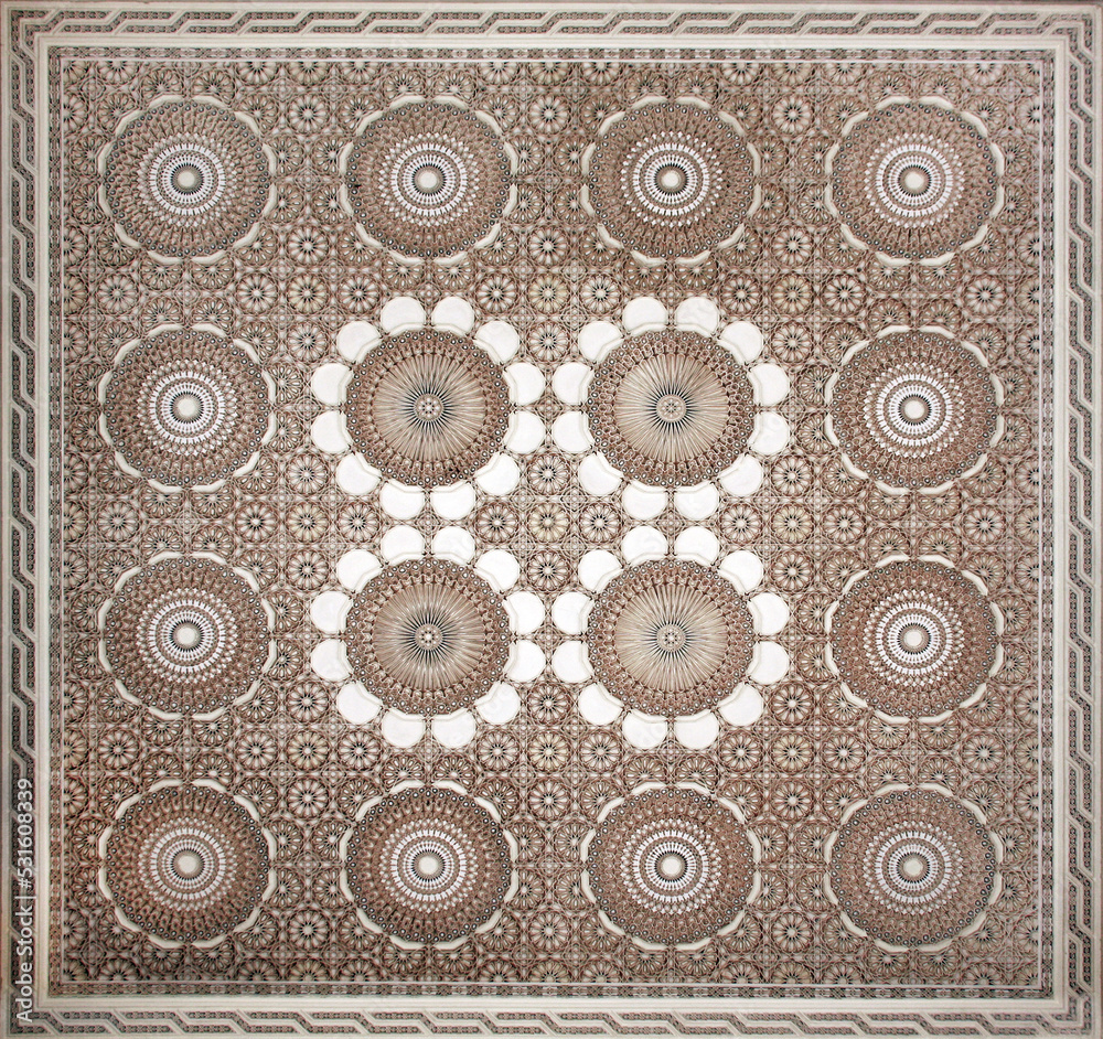 Ancient carved floral ornament in the Moroccan style. Square bas-relief with decorative element in arabic style