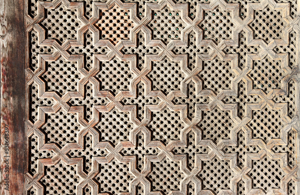 Detail of wooden door with traditional islamic ornament. Wood window shutter with antique and moroccan pattern