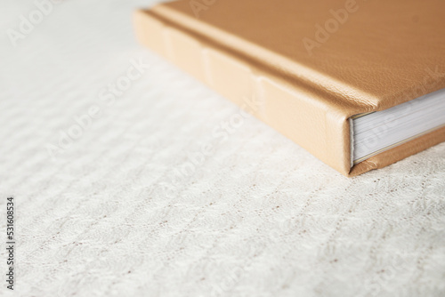 Photo book with leather cover. Stylish wedding or family photo album. Beautiful notepad or photobook with elegant embossing. Printing products. Individual products. Details