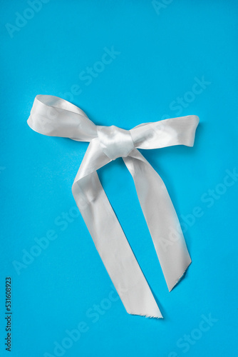 White bow on blue background