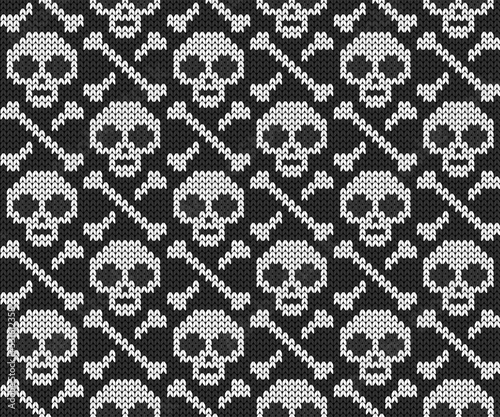 Knitted jacquard seamless pattern with skull and bones. Vector illustration.