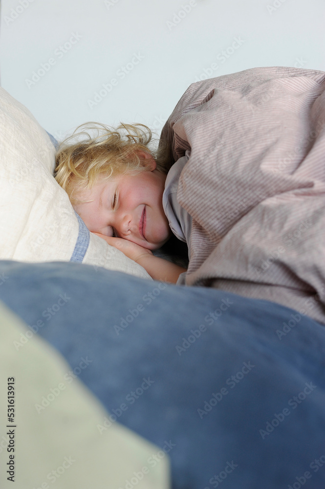 Smiling girl with eyes closed relaxing in bed Smiling girl with eyes closed relaxing in bed