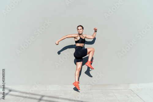 Young athlete jumping on sunny day photo