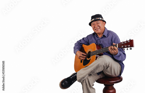 Studio portrait of senior man with hat playing guitar on white  background and space
