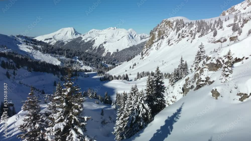 Low flyover through back country of Avoriaz Ski Resort, French Alps towards groomed ski run. Low flyover through back country of Avoriaz Ski Resort, French Alps towards groomed ski run.