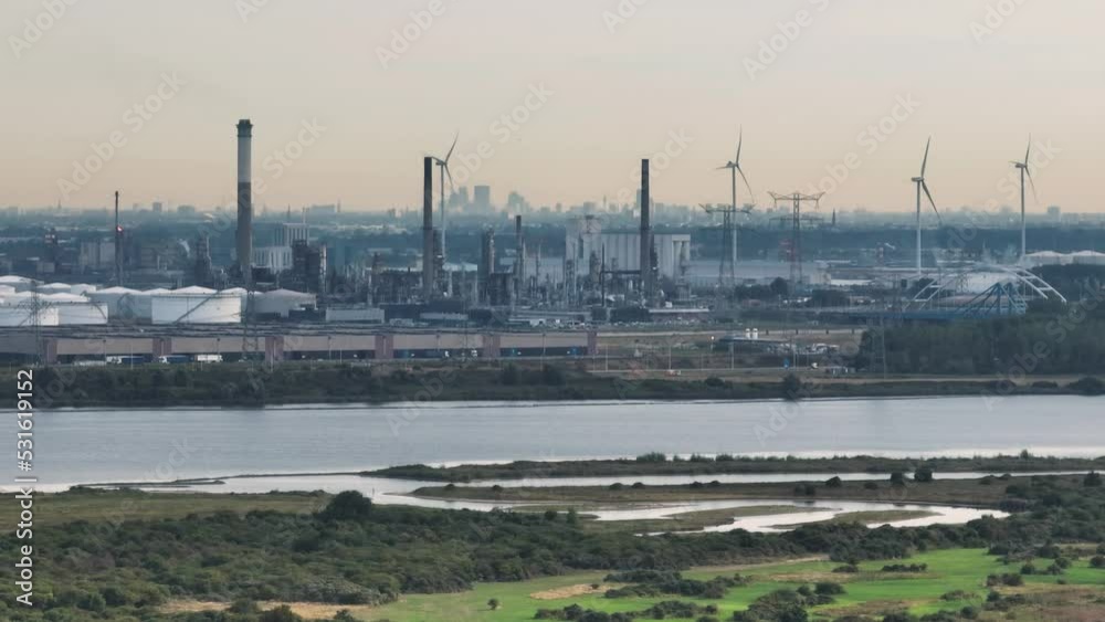 A commercial port in the Netherlands with wind turbines and various industries A commercial port in the Netherlands with wind turbines and various industries
