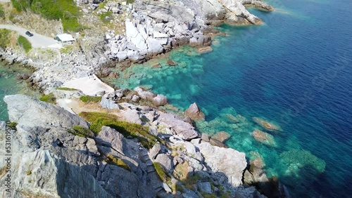 Panning Downwards Shot Of Tourists Walking Away From TheStunning Agios Ioannis Kastri That Appeared In Mamma Mia photo