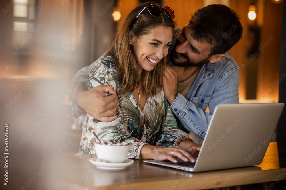Happy couple using laptop at cafe enjoying time together
Smiling looking at each other
Happy couple using laptop at cafe enjoying time together
Smiling looking at each other