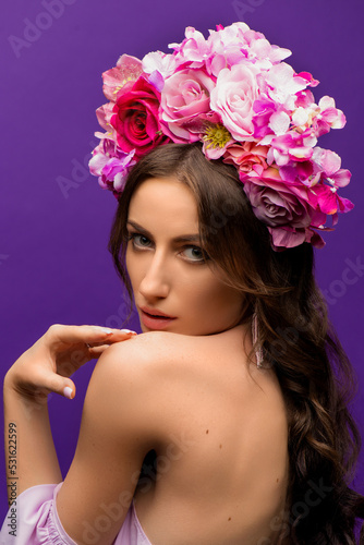 Portrait of a Young Woman with Wreath of Pink Flowers on purple Background. Natural Beauty Concept. Ukrainian girl. Save Ukraine
