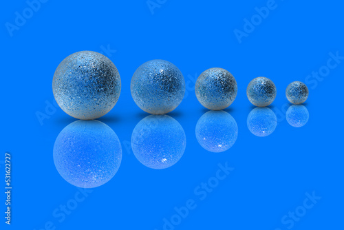 Five balls of metal of different sizes of blue color on blue background. Growth of something. Progress. Reflection. Horizontal image. 3D image. 3D rendering.