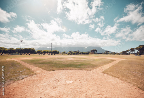 Empty baseball field, stadium or sport softball park for competition, training or tournament match. Sports, ball game or exercise, recreation or grass lawn nature area with pitch circle blue sky view photo