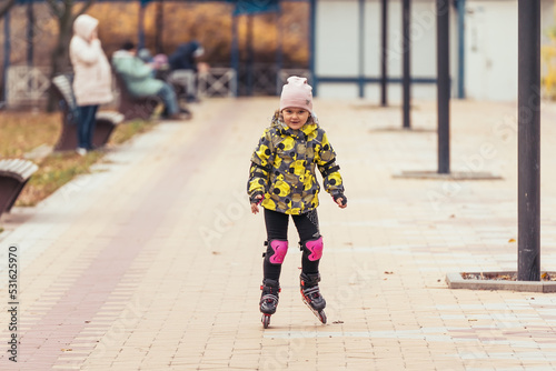Cute little girl learning to roller skate