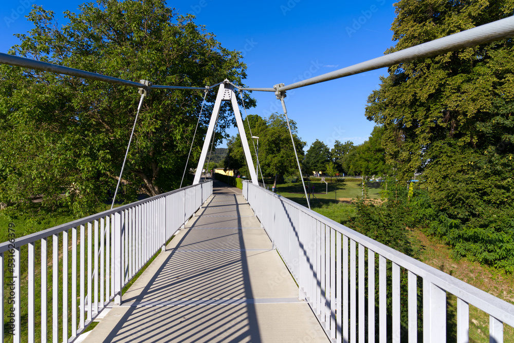 Pedestrian rope bridge over Thur River at village Kleinandelfingen, Canton Zürich, on a sunny summer morning. Photo taken July 12th, 2022, Kleinandelfingen, Switzerland. Pedestrian rope bridge over Thur River at village Kleinandelfingen, Canton Zürich, on a sunny summer morning. Photo taken July 12th, 2022, Kleinandelfingen, Switzerland.