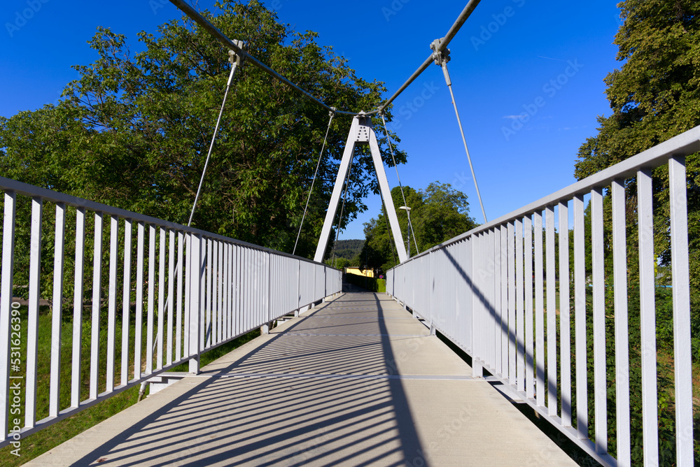 Pedestrian rope bridge over Thur River at village Kleinandelfingen, Canton Zürich, on a sunny summer morning. Photo taken July 12th, 2022, Kleinandelfingen, Switzerland. Pedestrian rope bridge over Thur River at village Kleinandelfingen, Canton Zürich, on a sunny summer morning. Photo taken July 12th, 2022, Kleinandelfingen, Switzerland.