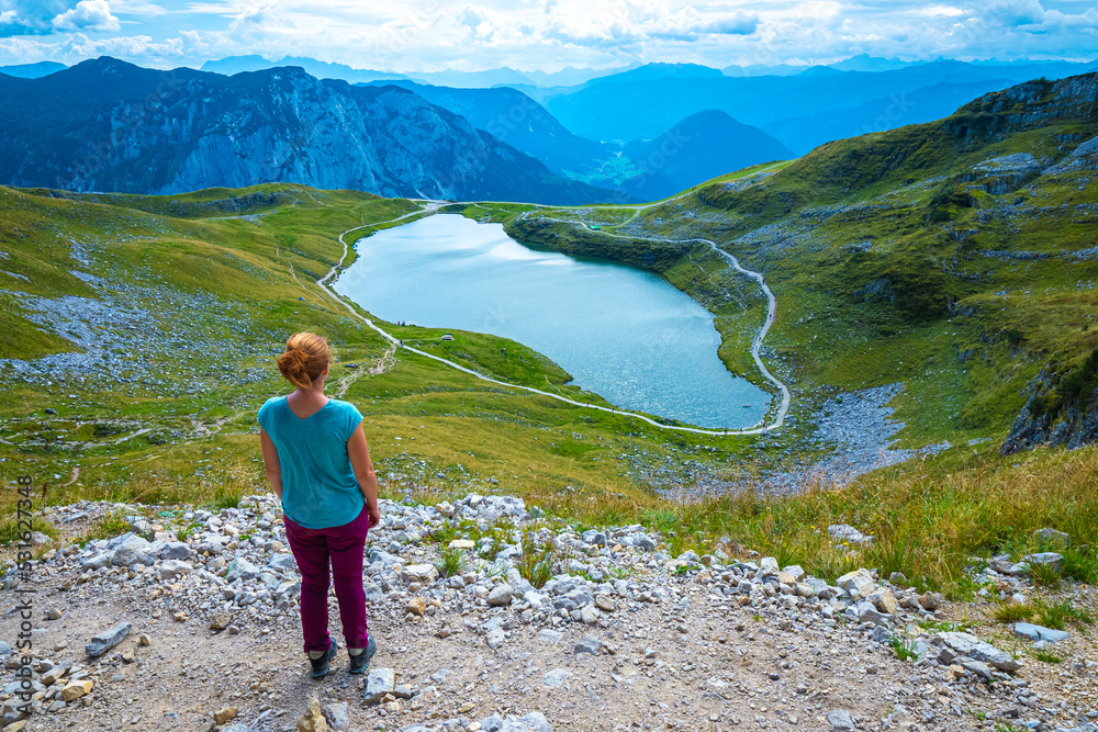 Female hiker enjoying view of the Augstsee on top of the Loser and the surrounding mountain range, Ausseer Land, Salzkammergut, Styria, Austria