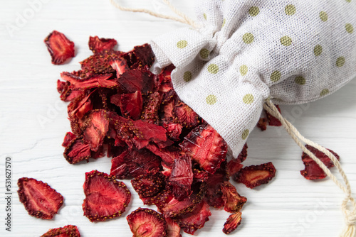 Dried strawberries on a white background with a place for text. Preparations for a pleasant and healthy tea party.