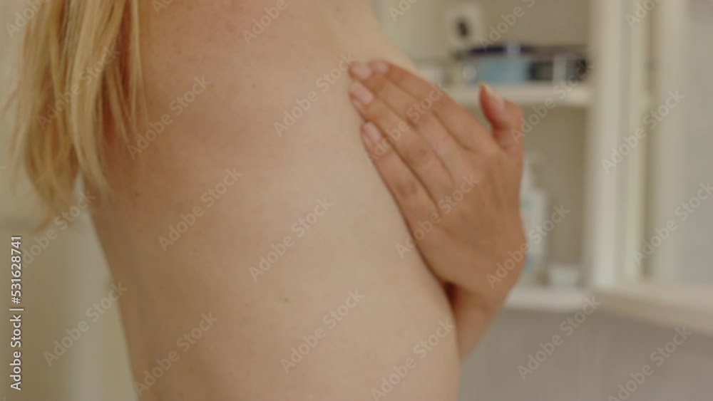 side view of woman's hand check breast for lumps in breast cancer exam side view of woman's hand check breast for lumps in breast cancer exam