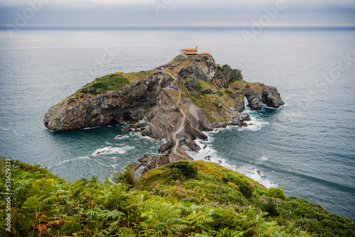 Scenic view of San Juan de Gaztelugatxe Gaztelugatxeko Doniene an hermitage on top of a rock in the sea photo