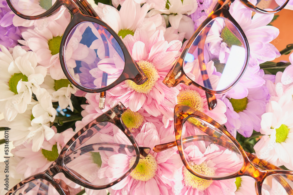 several trendy modern eye glasses on flowers. trendy eyeglasses Stock Adobe Stock