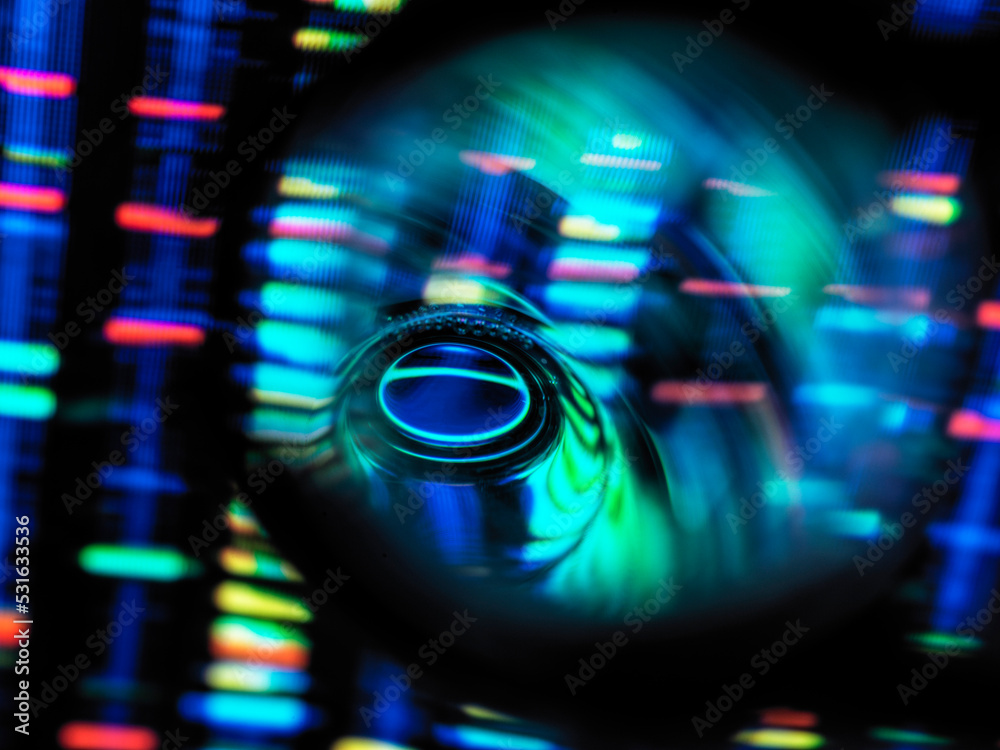 © Connect Images - Detail of test tube with illuminated genetic data in background