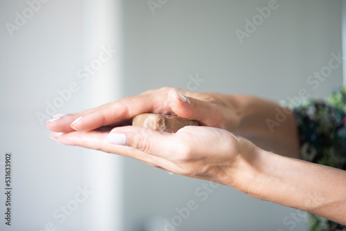 Woman holding soap, close up of hands photo