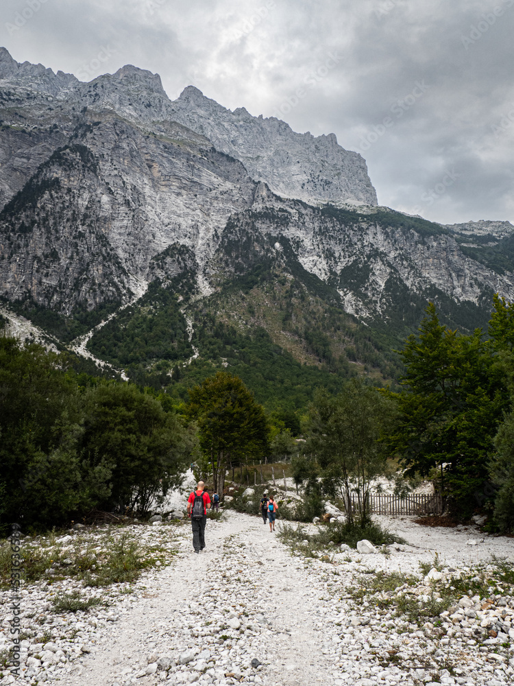 Hikers in the mountains in Theth valley in Albania