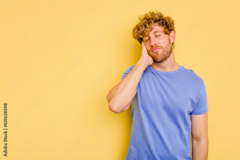 Young caucasian man isolated on yellow background who feels sad and pensive, looking at copy space. Young caucasian man isolated on yellow background who feels sad and pensive, looking at copy space.