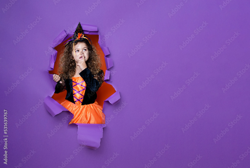 Happy little child girl in costumes and makeup having fun on Halloween celebration
Happy little child girl in costumes and makeup having fun on Halloween celebration
