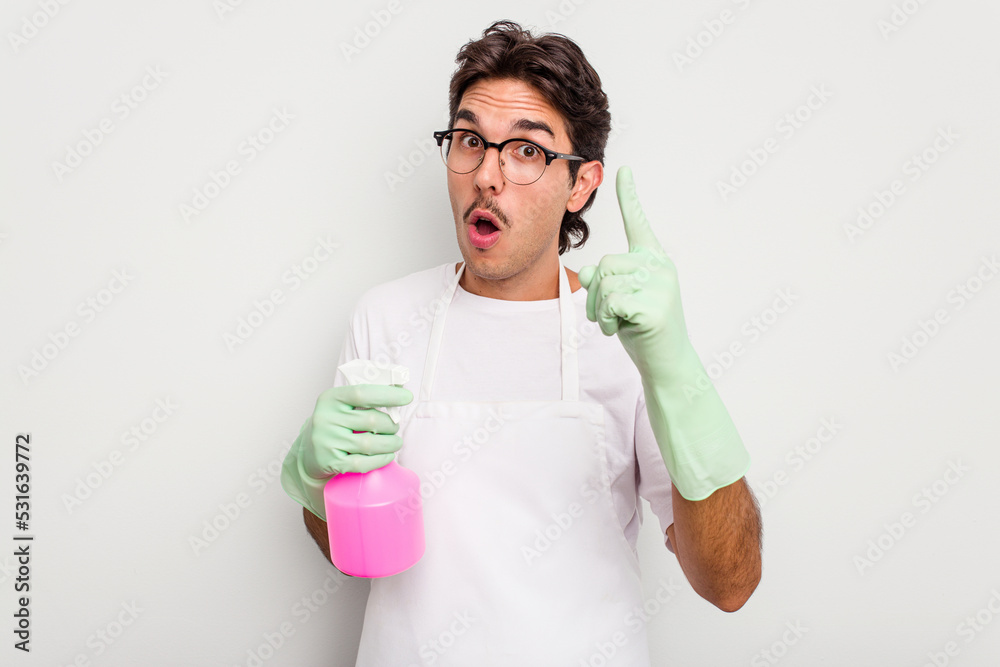 Young cleaner hispanic man isolated on white background having an idea, inspiration concept.