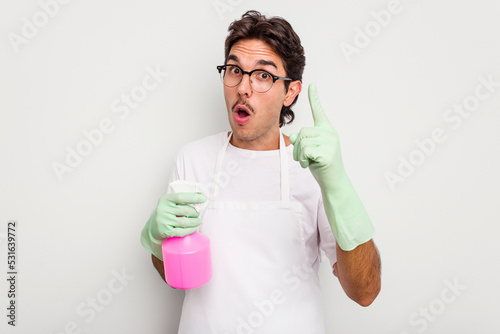 Young cleaner hispanic man isolated on white background having an idea, inspiration concept.