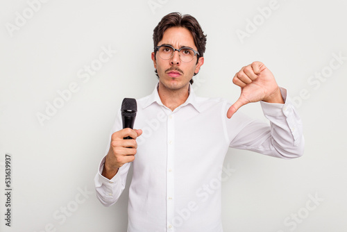 Young hispanic singer man isolated on white background showing a dislike gesture, thumbs down. Disagreement concept.