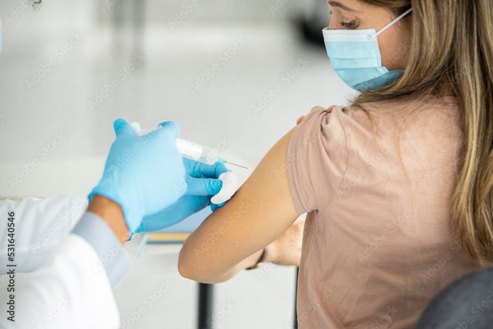 Close up of a doctors hands giving vaccine Close up of a doctors hands giving vaccine