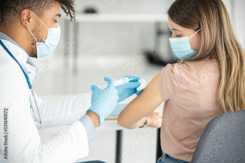 Fototapeta Naklejka Na Ścianę i Meble -  Close up of a doctors hands giving vaccine