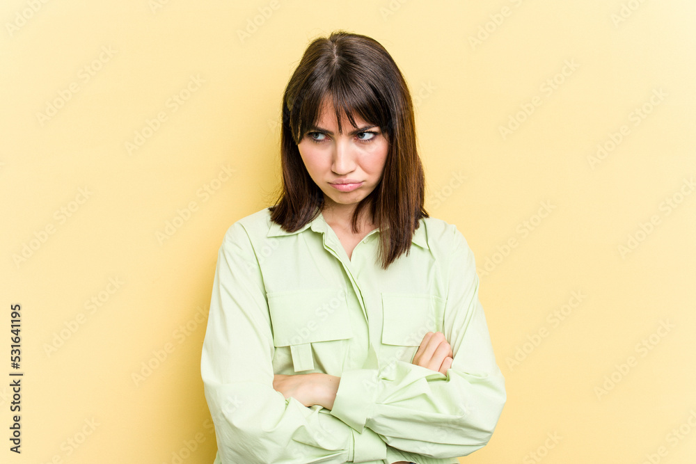 Young caucasian woman isolated on yellow background tired of a repetitive task. Young caucasian woman isolated on yellow background tired of a repetitive task.