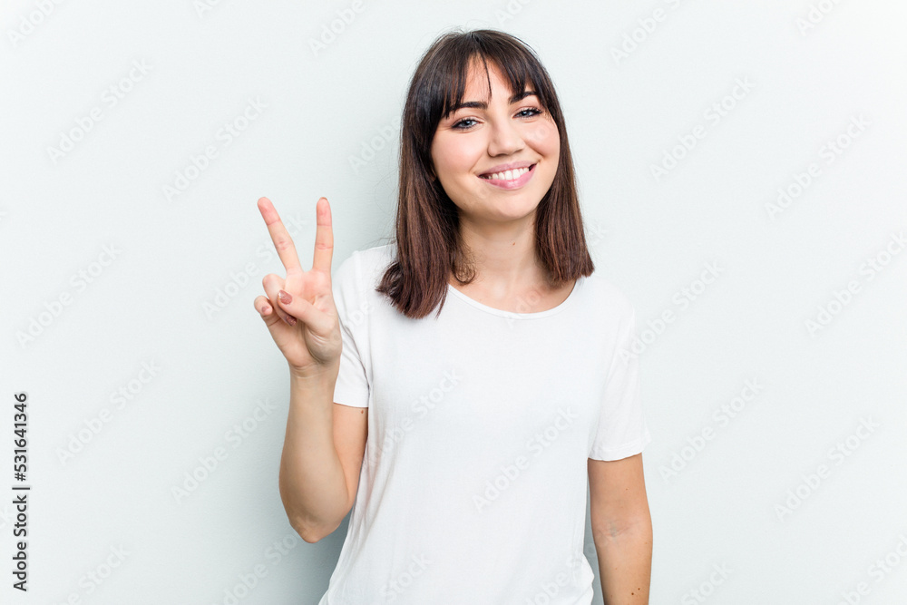 Young caucasian woman isolated on white background showing victory sign and smiling broadly. Young caucasian woman isolated on white background showing victory sign and smiling broadly.