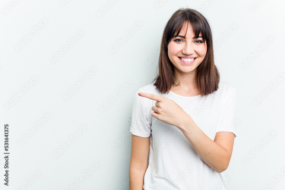 Young caucasian woman isolated on white background smiling and pointing aside, showing something at blank space. Young caucasian woman isolated on white background smiling and pointing aside, showing something at blank space.