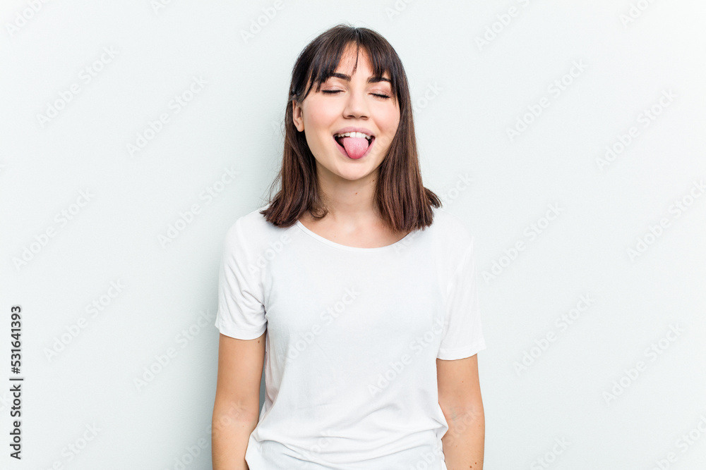 Young caucasian woman isolated on white background funny and friendly sticking out tongue. Young caucasian woman isolated on white background funny and friendly sticking out tongue.